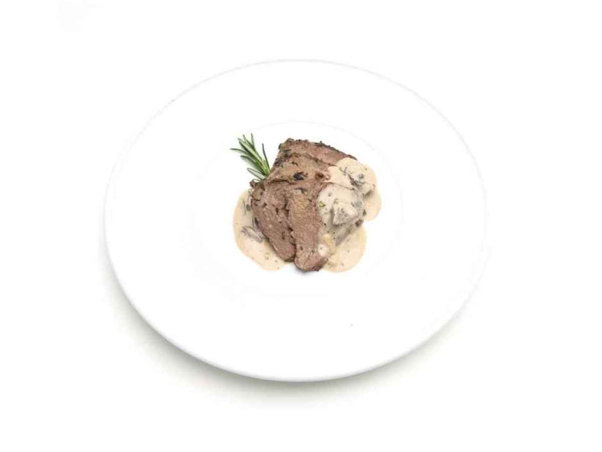 a plate of food Made with beef tenderloin, red wine, shallots, and mushrooms. Gluten Free. Contains Dairy.
