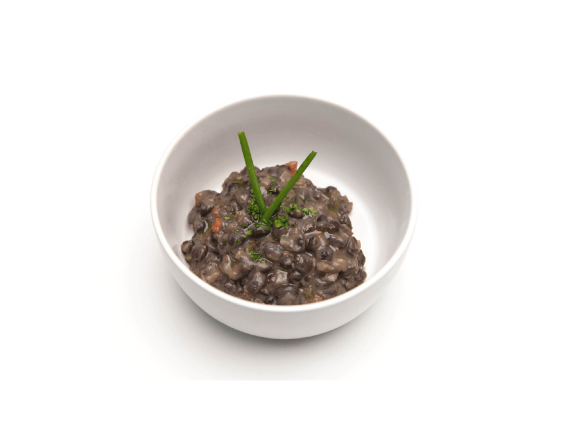 a bowl of food on a plate Made with beans, peppers, onions, and herbs. Gluten Free.