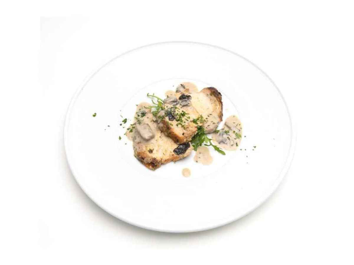 a plate of food Made with grilled chicken breast, red wine, shallots, and mushrooms. Gluten Free. Contains Dairy.