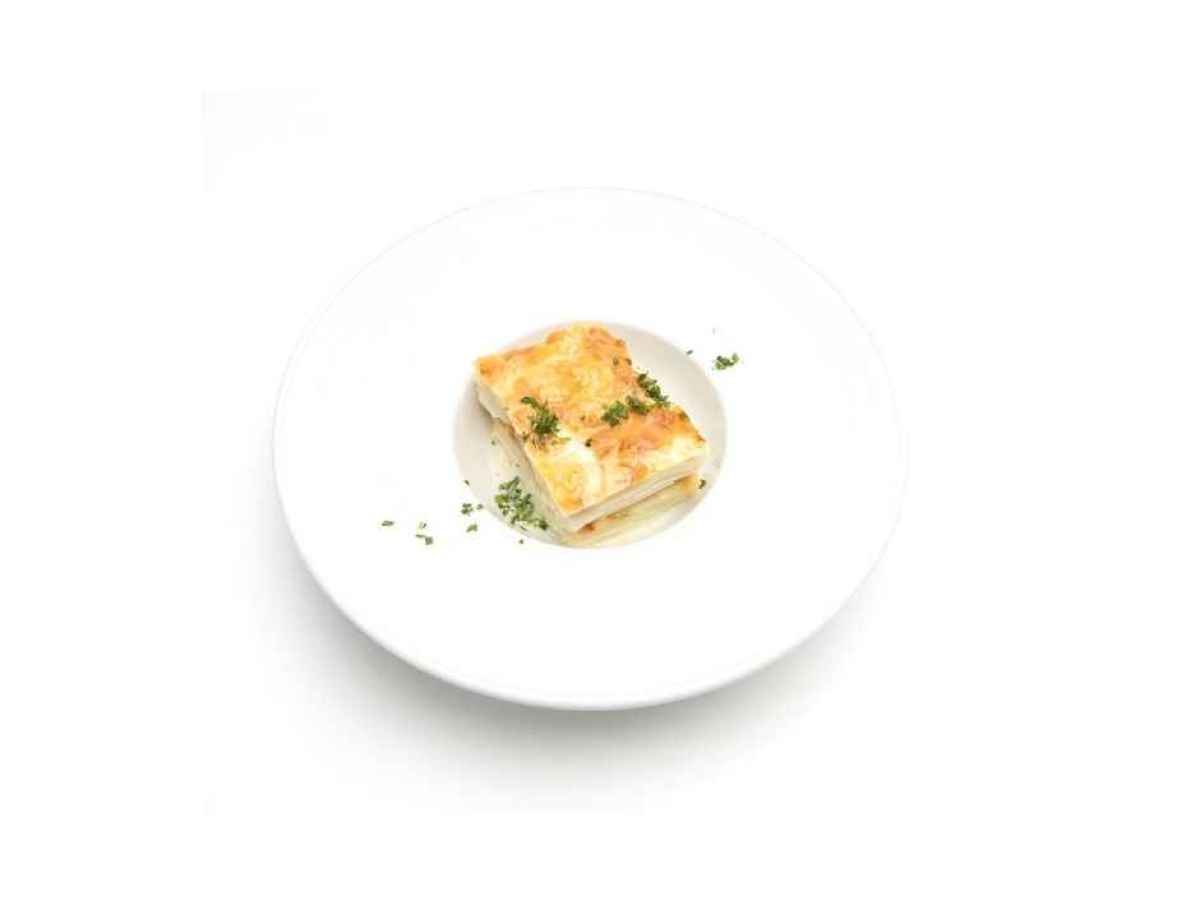 a piece of food on a plate Made with russet potatoes, cream, butter, and parmesan cheese. Gluten Free. Contains Dairy.
