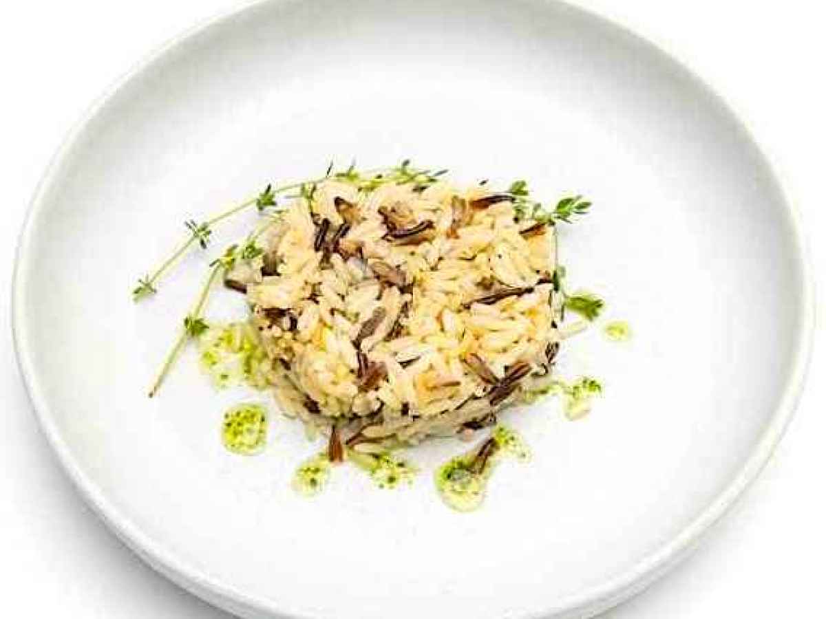 a bowl of food on a plate Made with rice, onions, and chicken stock. Gluten Free.