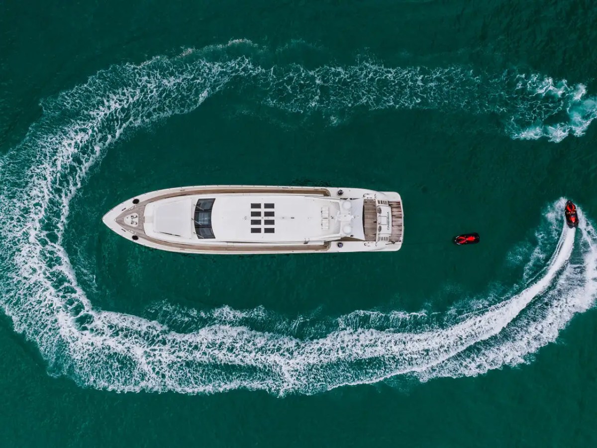 Overhead drone shot of 101′ Leopard Miami with jetski circling
