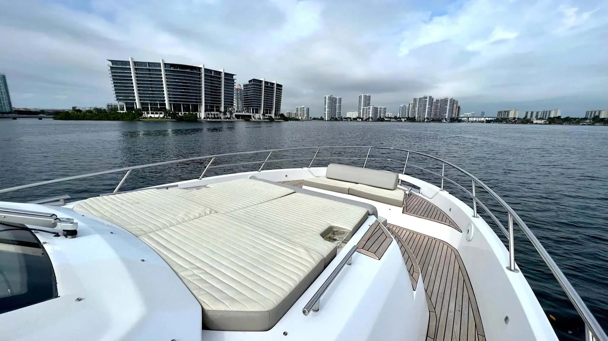 Sunlit teak deck of 42′ Azimut yacht