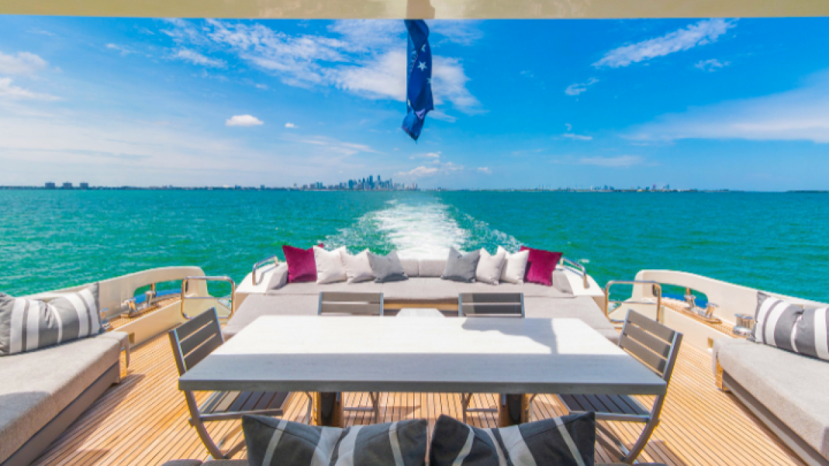 Aft deck dining setup on 103′ Azimut Miami