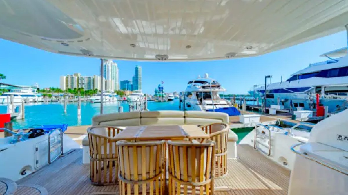 75' Sunseeker yacht charter aft deck dining area with Miami Beach marina views