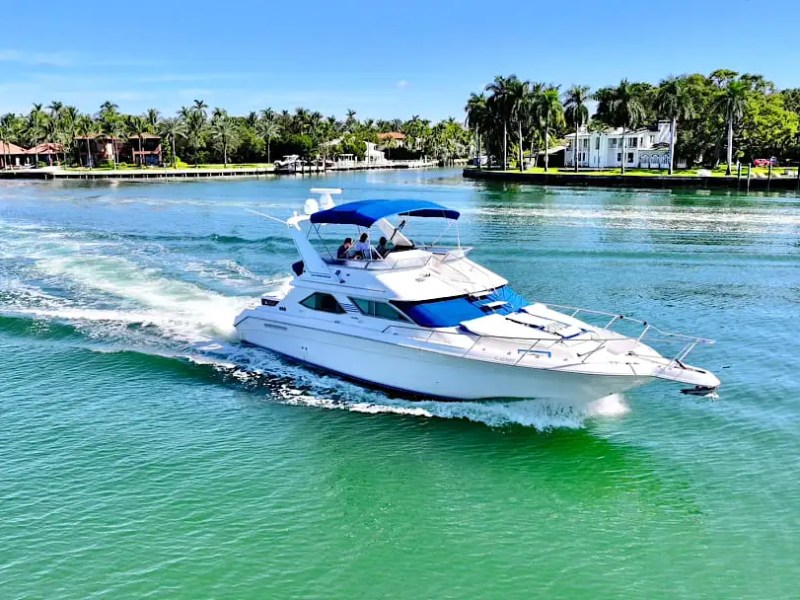 48′ SeaRay boat aerial view cruising Miami Beach waters
