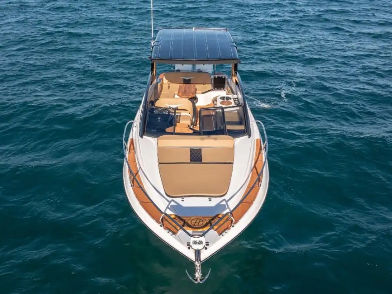 A drone shot captures the 33 foot Hanover Boat Rental underway in Palm Beach waters, highlighting the spacious bow sun pad and sleek profile of this luxury Boat Rental.