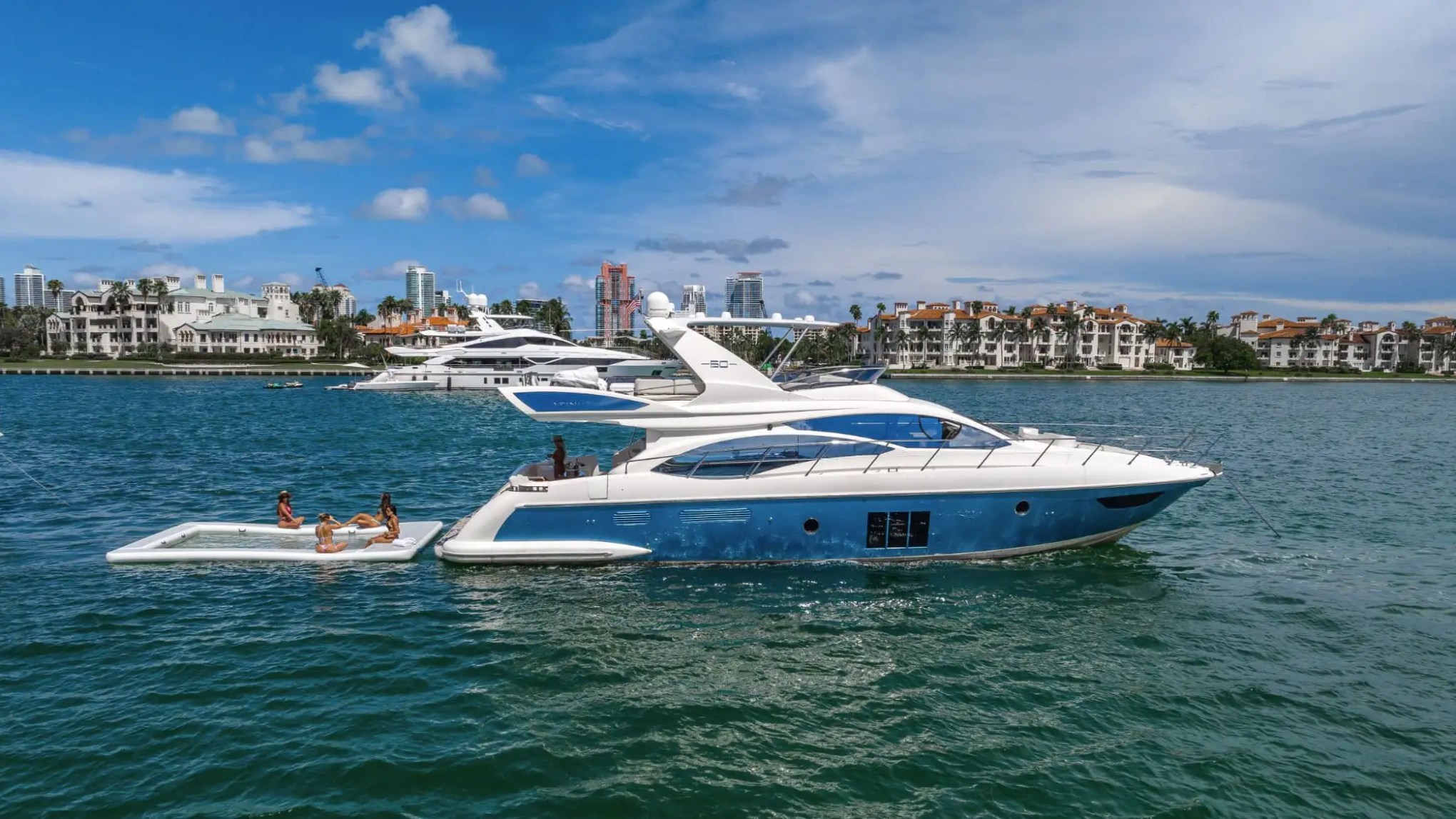 62′ Azimut yacht anchored with water toys behind stern