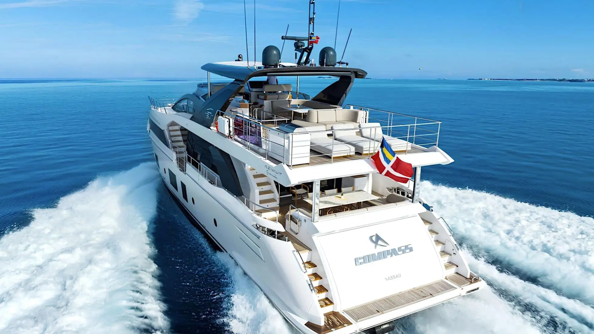 Low-orbit aerial pass along hull of 88′ Azimut Miami