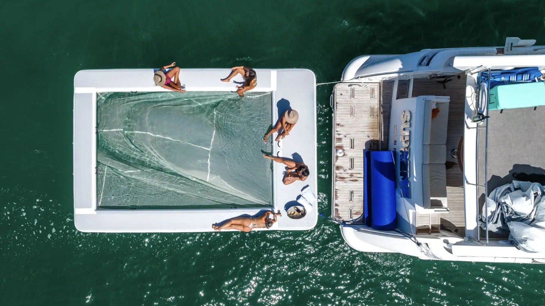 Magic carpet water toy deployed behind 62′ Azimut yacht rental at anchor