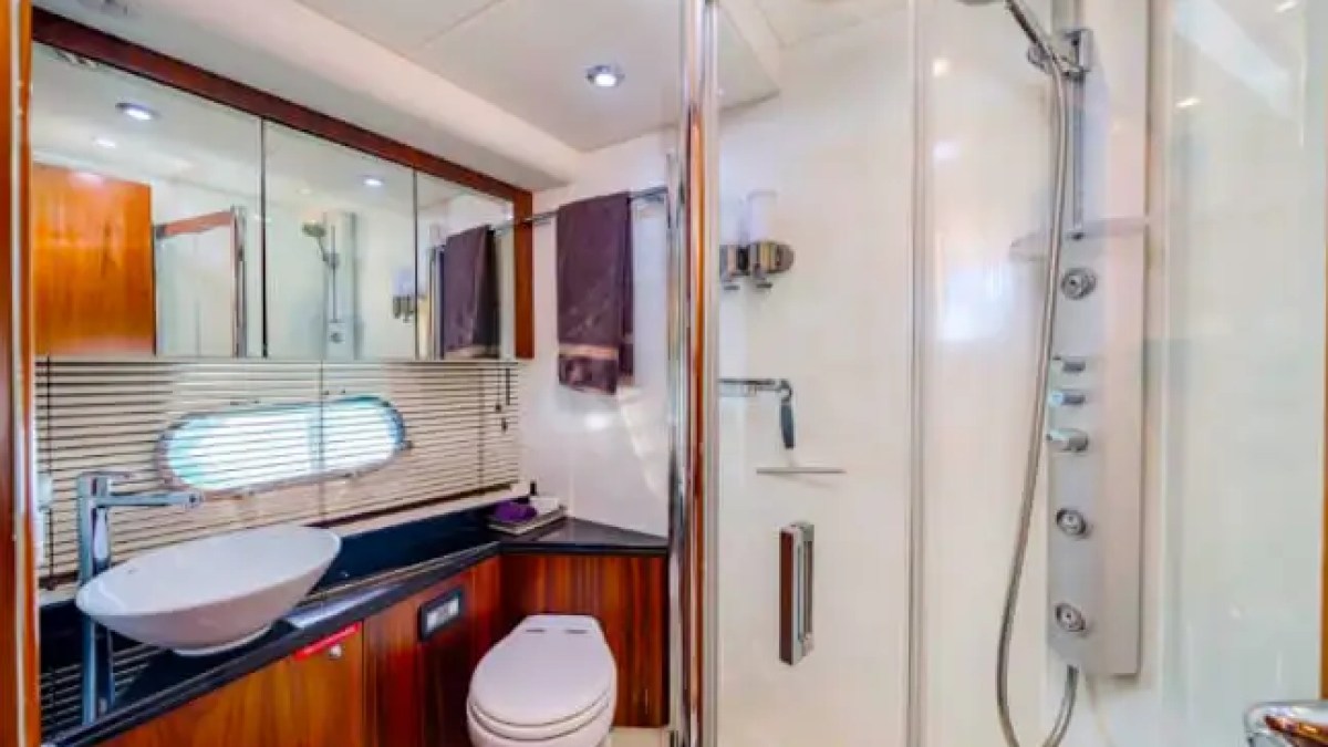75' Sunseeker yacht charter guest bathroom with glass shower and vanity in Miami Beach