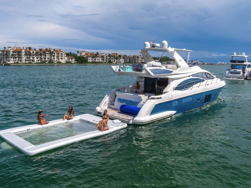 62′ Azimut yacht anchored with water toys behind stern