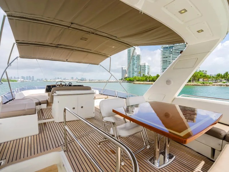 Flybridge table on the 62′ Prestige luxury yacht rental in Miami Beach