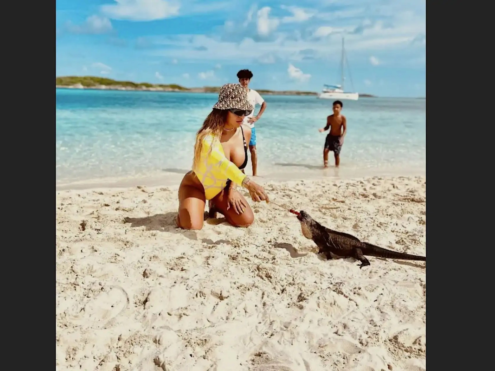Guests visiting a secluded Nassau Bahamas beach during a 35' Marlin Boat Rental excursion, enjoying shallow turquoise waters, white sand shoreline, and a unique island wildlife encounter.