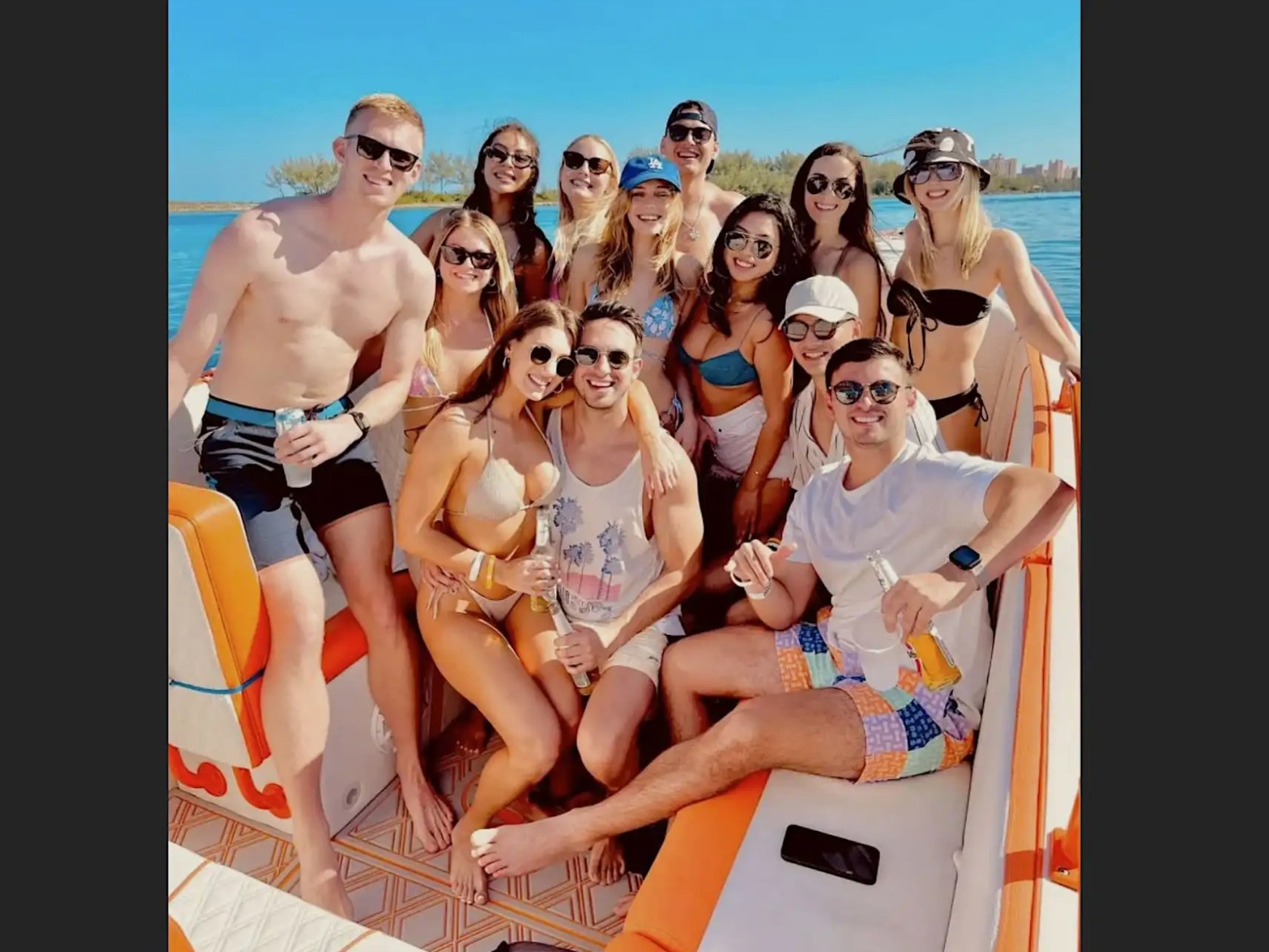 Large group enjoying a 35' Marlin Boat Rental in Nassau, Bahamas, featuring spacious seating, social island hopping, turquoise waters, and a fun-filled tropical boating adventure.