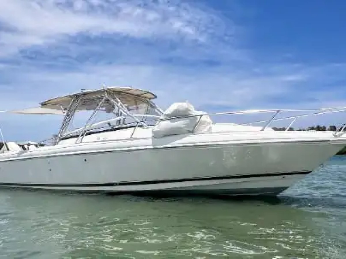 37 foot Intrepid center console boat rental floating in clear coastal waters near Pompano Beach, Florida with a hardtop helm, open bow layout, and sleek performance hull visible.