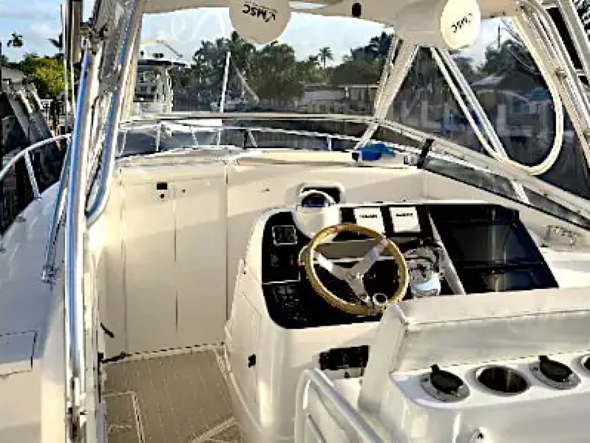 37 foot Intrepid center console boat rental helm station in Pompano Beach, Florida featuring dual displays, captain controls, hardtop protection, and wide walkaround decks.