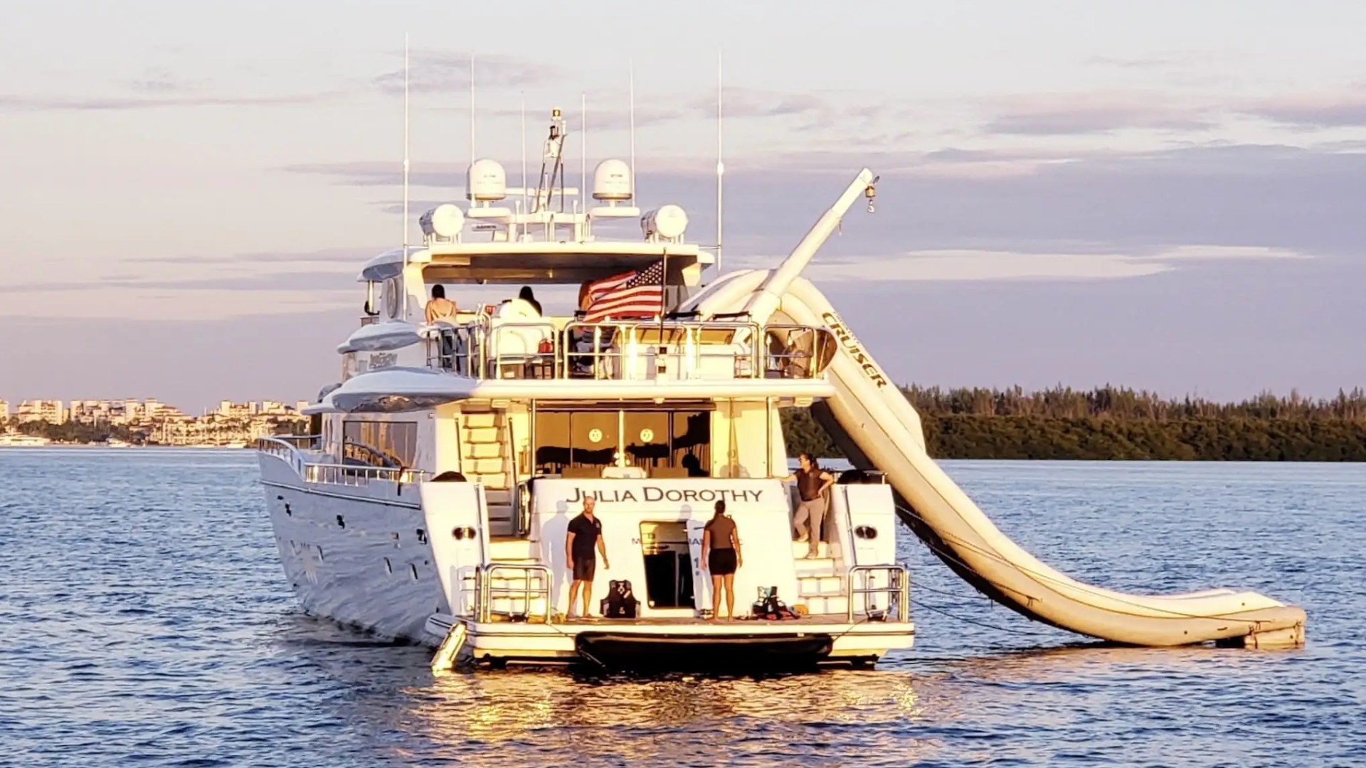 Giant inflatable slide from the top deck of this charter yacht, the 103′ Johnson Key Biscayne