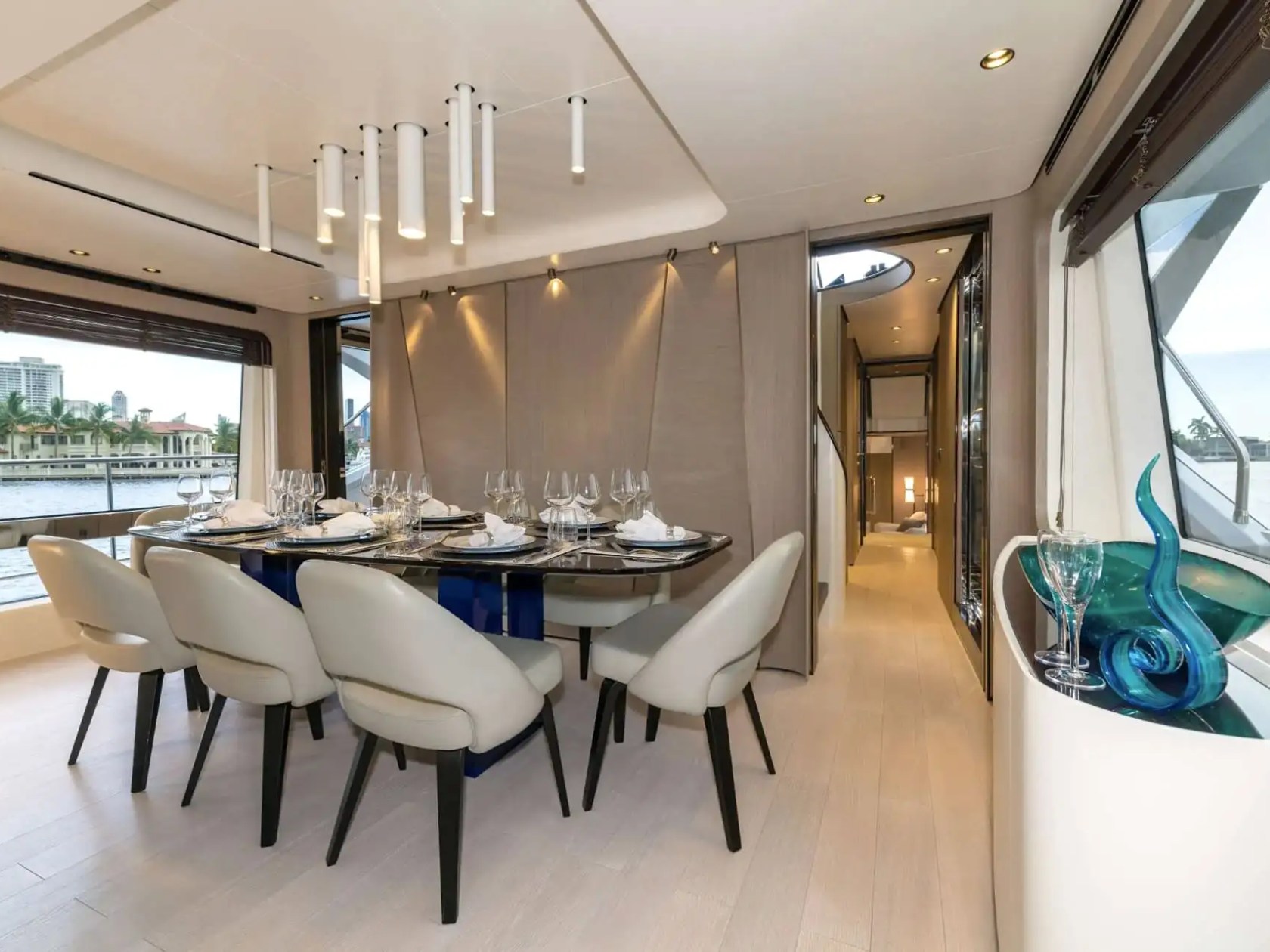 88 Azimut Yacht Charter formal dining area featuring elegant table settings, contemporary lighting, waterfront windows, and refined interior design in Nassau Bahamas
