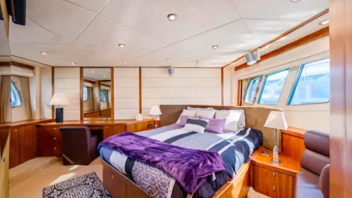 75' Sunseeker yacht charter master stateroom interior with large bed in Miami Beach