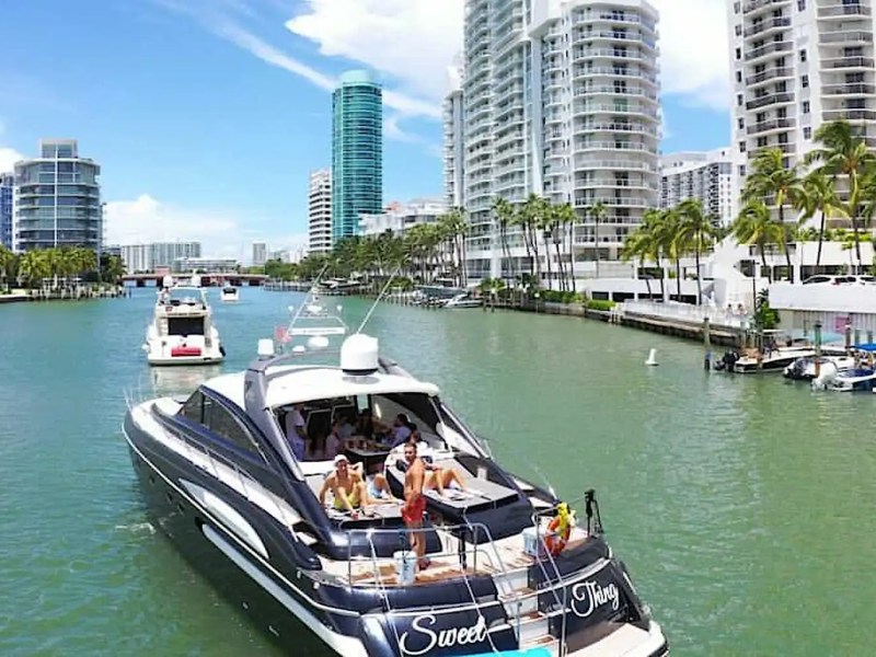 70' Princess yacht charter cruising Miami Beach waterways with guests