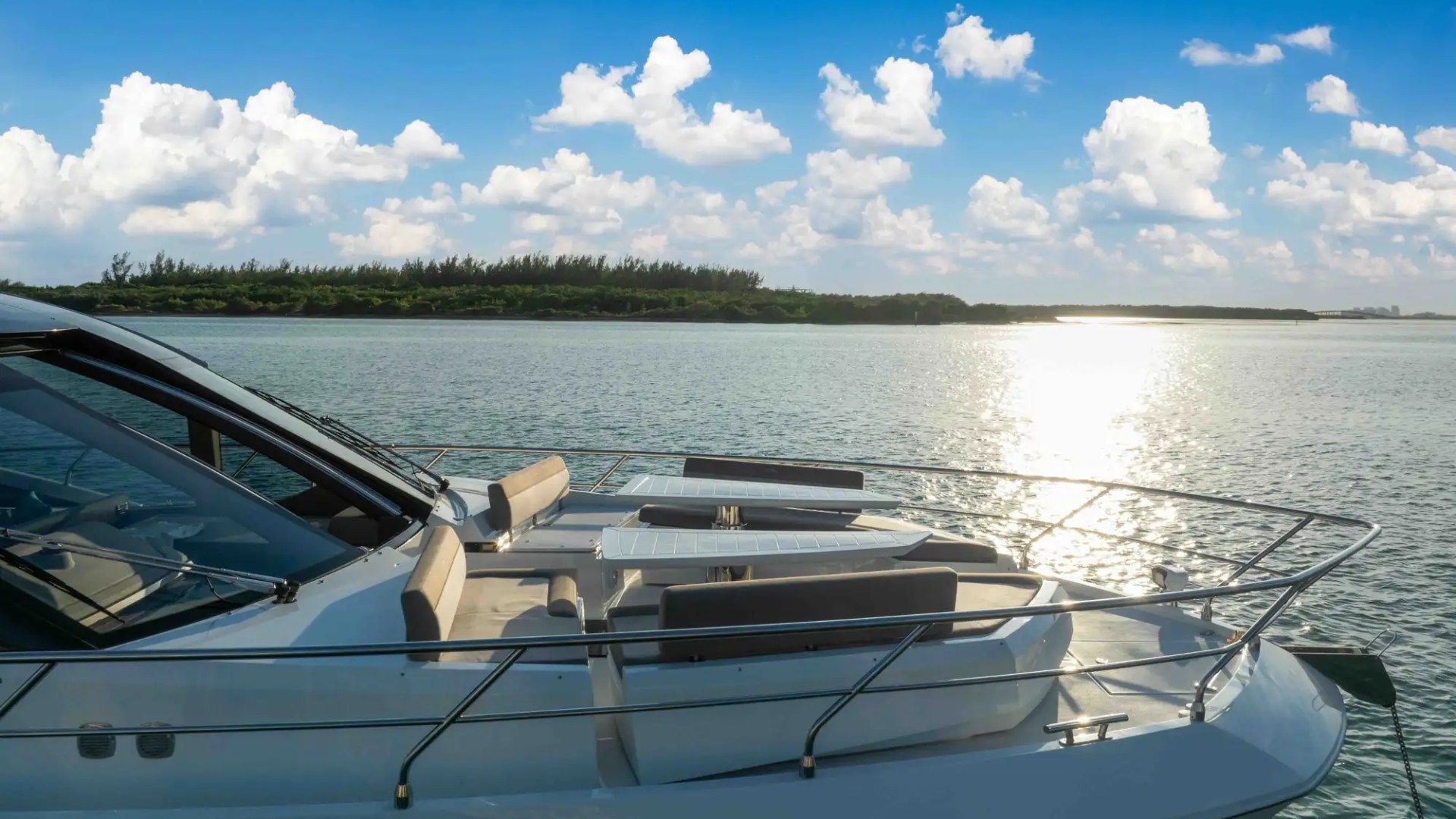 68' Galeon yacht charter Miami bow lounge seating at sunset