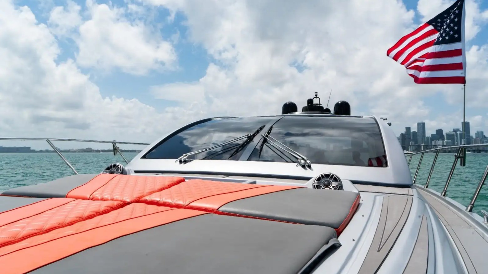 Bow social seating with skyline backdrop on 64′ Atlantis Miami