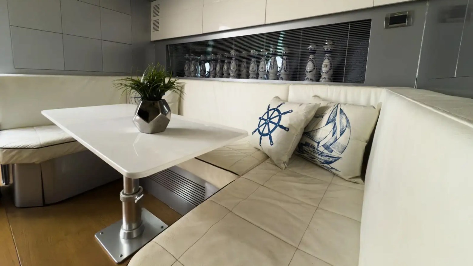 Indoor dining table setup on 64′ Atlantis Miami