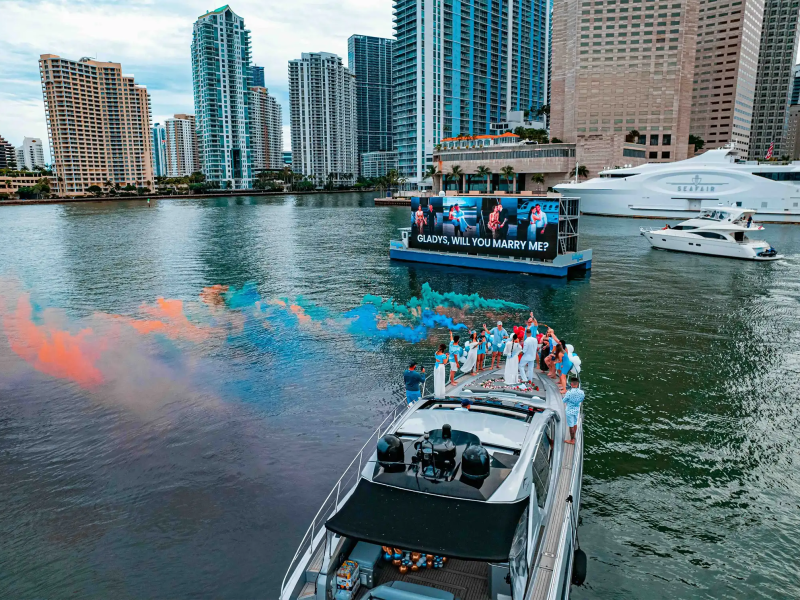 Guests celebrating on bow of 64′ Atlantis Miami