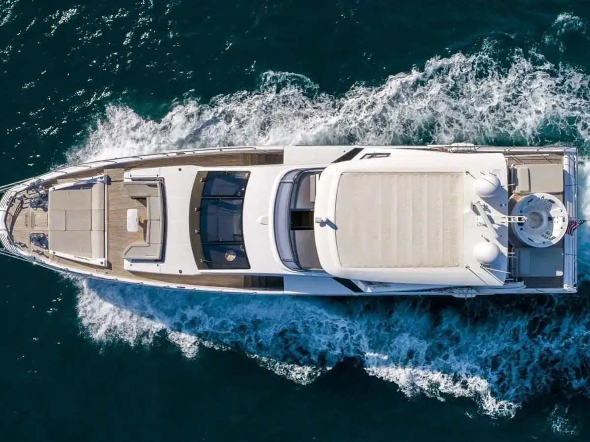 88′ Azimut swim platform Nassau88 Azimut Yacht Charter captured from an aerial view cruising through turquoise Bahamas waters, showcasing expansive decks, sleek profile, and open-sea performance