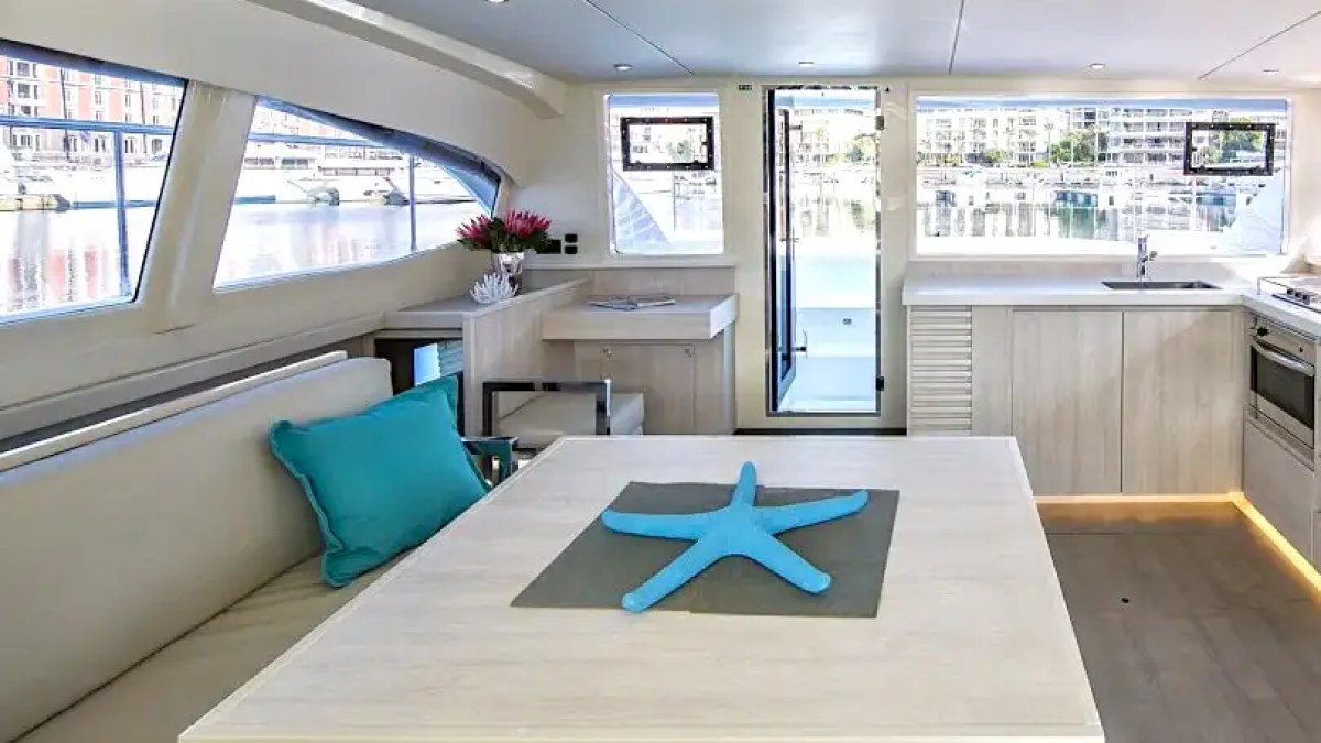 Bright salon interior with panoramic windows aboard 43′ Leopard