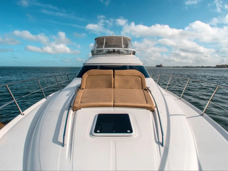 58′ SeaRay yacht charter bow sunpad with cushioned loungers overlooking open water and the Fort Lauderdale coastline.