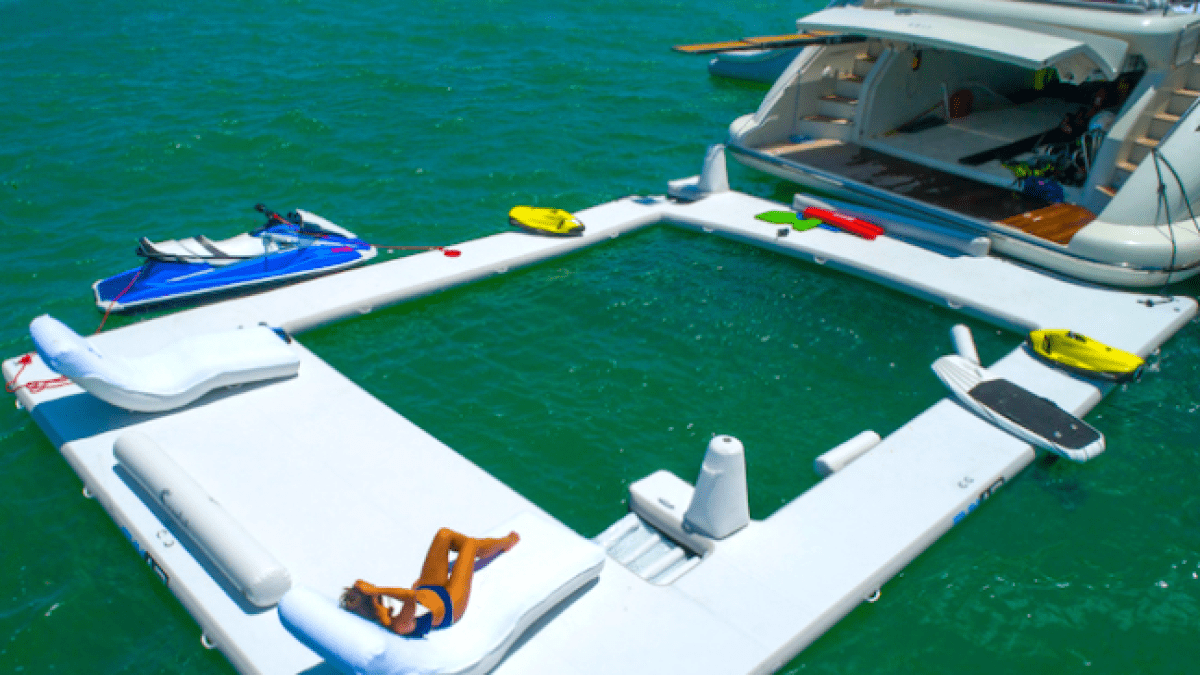 Floating lounge beside yacht on 103′ Azimut Miami