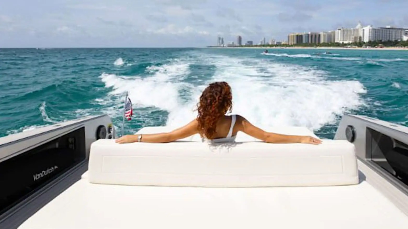 Guest enjoying aft deck seating aboard 55′ VanDutch yacht in Miami Beach