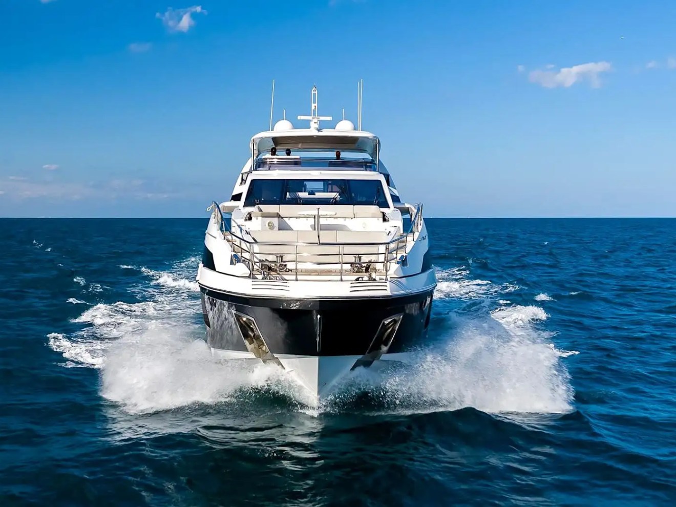 88 Azimut Yacht Charter underway in Nassau waters, showcasing a powerful bow profile, ocean spray, and luxury cruising performance across The Bahamas