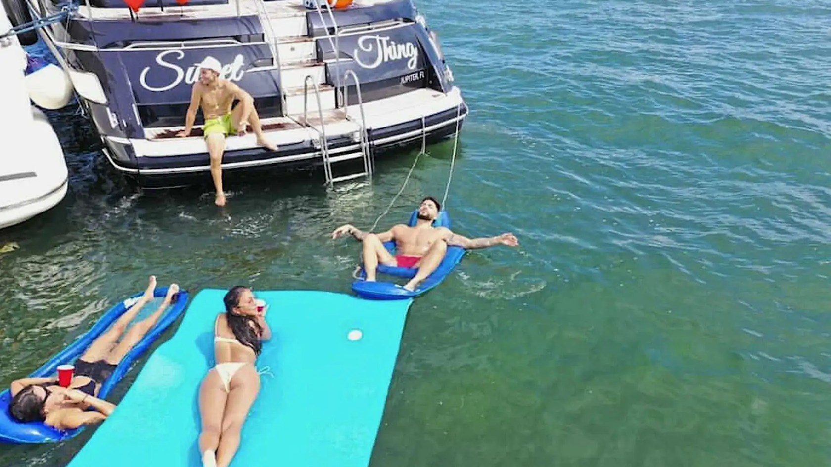 70' Princess yacht charter guests floating on water mat Miami Beach