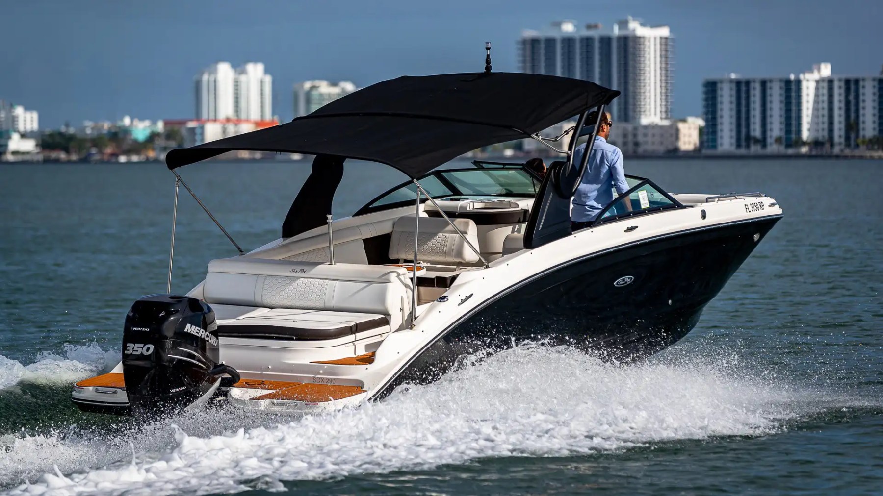 Side aerial drone pass of 29′ Sea Ray Miami Beach