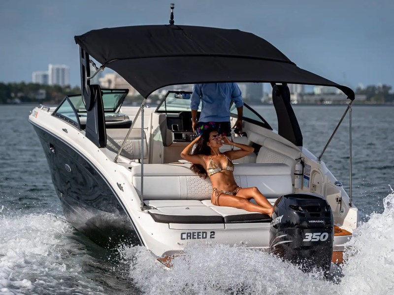 29' Sea Ray Boat Rental cruising through South Florida waters with aft sun pad seating, Mercury outboard power, hardtop shade, and open-water relaxation