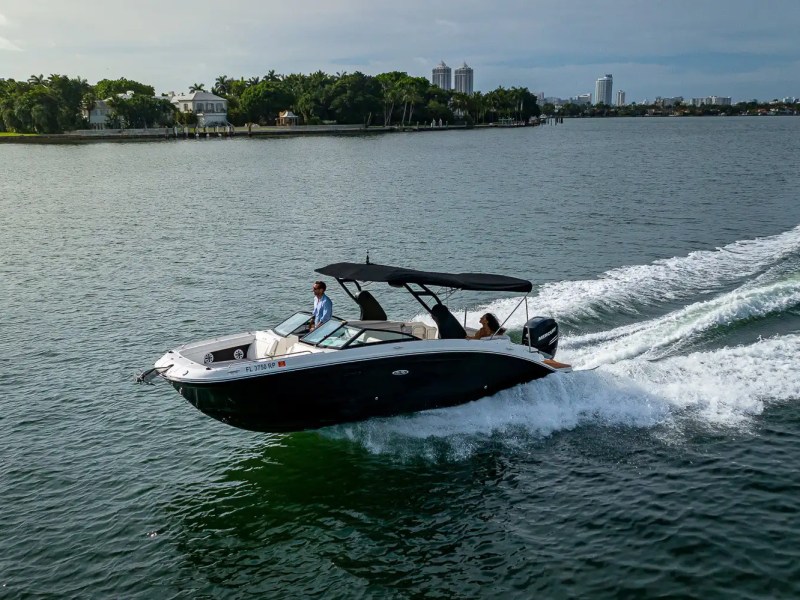 29' Sea Ray Boat Rental captured in an aerial cruising view across Miami Beach waterways, featuring open-water performance, shaded cockpit seating, and South Florida coastal scenery