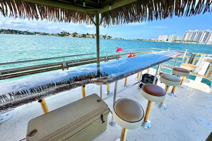 Under-roof dining table on 30′ Tiki – Miami