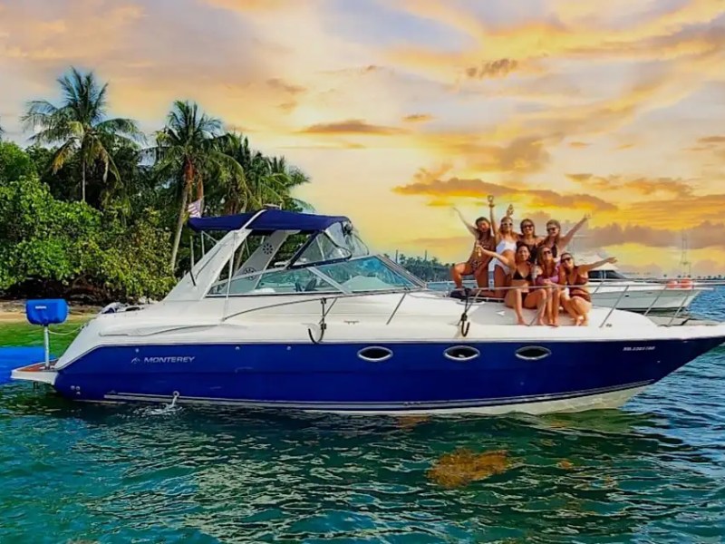 Side drone aerial cruising on 36′ Monterey Miami Beach