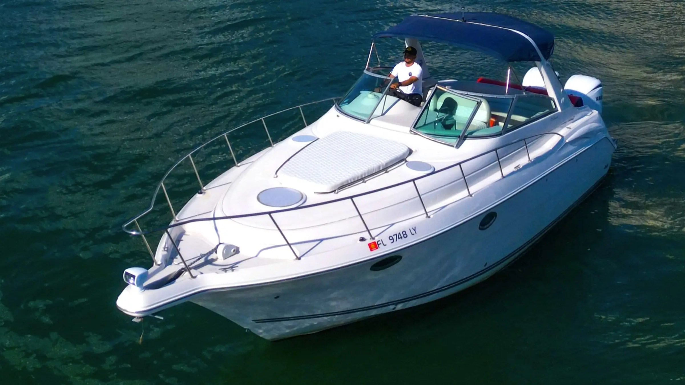 Captain at helm underway on 37′ Monterey Miami