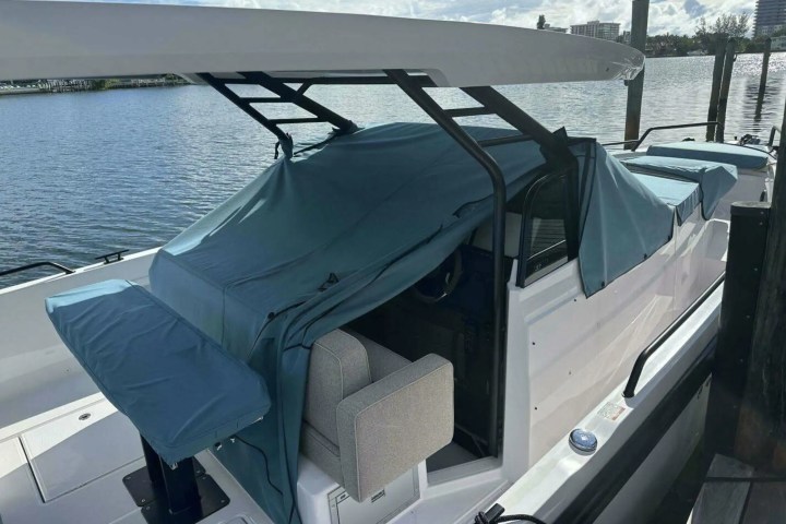 Boat at dock with protective blue covering.