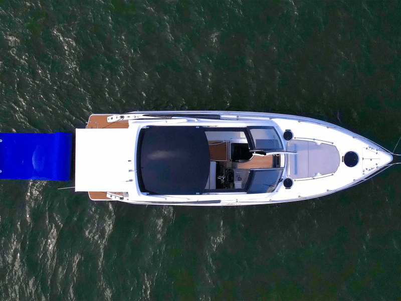 40 Schaefer Boat Rental aerial view in Miami showing the full vessel layout, blue floating water mat, swim platform, and Biscayne Bay waters from a top-down perspective.