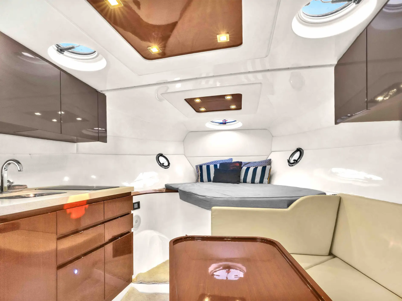 40 Schaefer Boat Rental cabin interior in Miami featuring a forward berth, wood cabinetry, skylights, lounge seating, and comfortable Biscayne Bay accommodations.