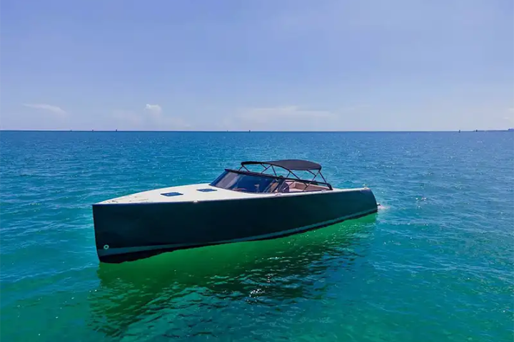 Sleek modern boat on calm turquoise sea under clear blue sky.