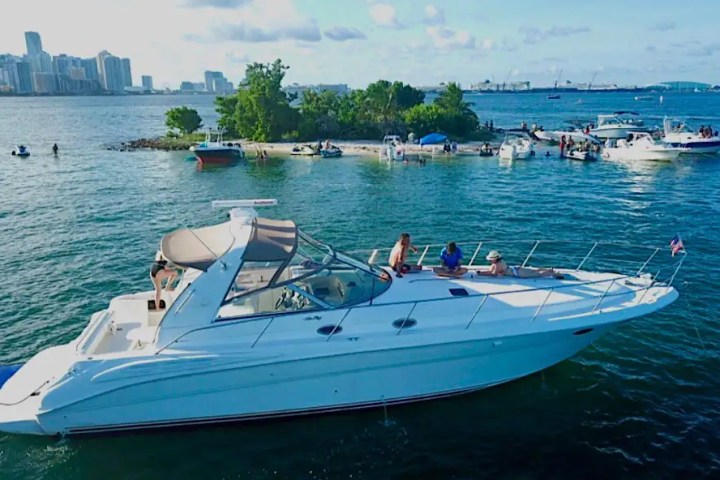 Aerial skyline + boat anchor scene on 42′ Sea Ray Miami