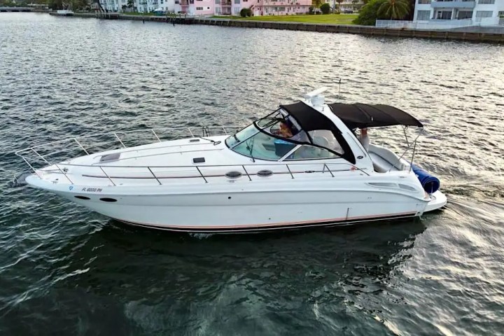 Aerial skyline + boat anchor scene on 42′ Sea Ray Miami