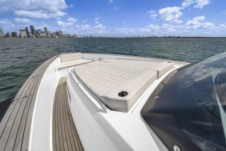 Luxury boat deck with seating and downtown skyscrapers in the distance across the water.