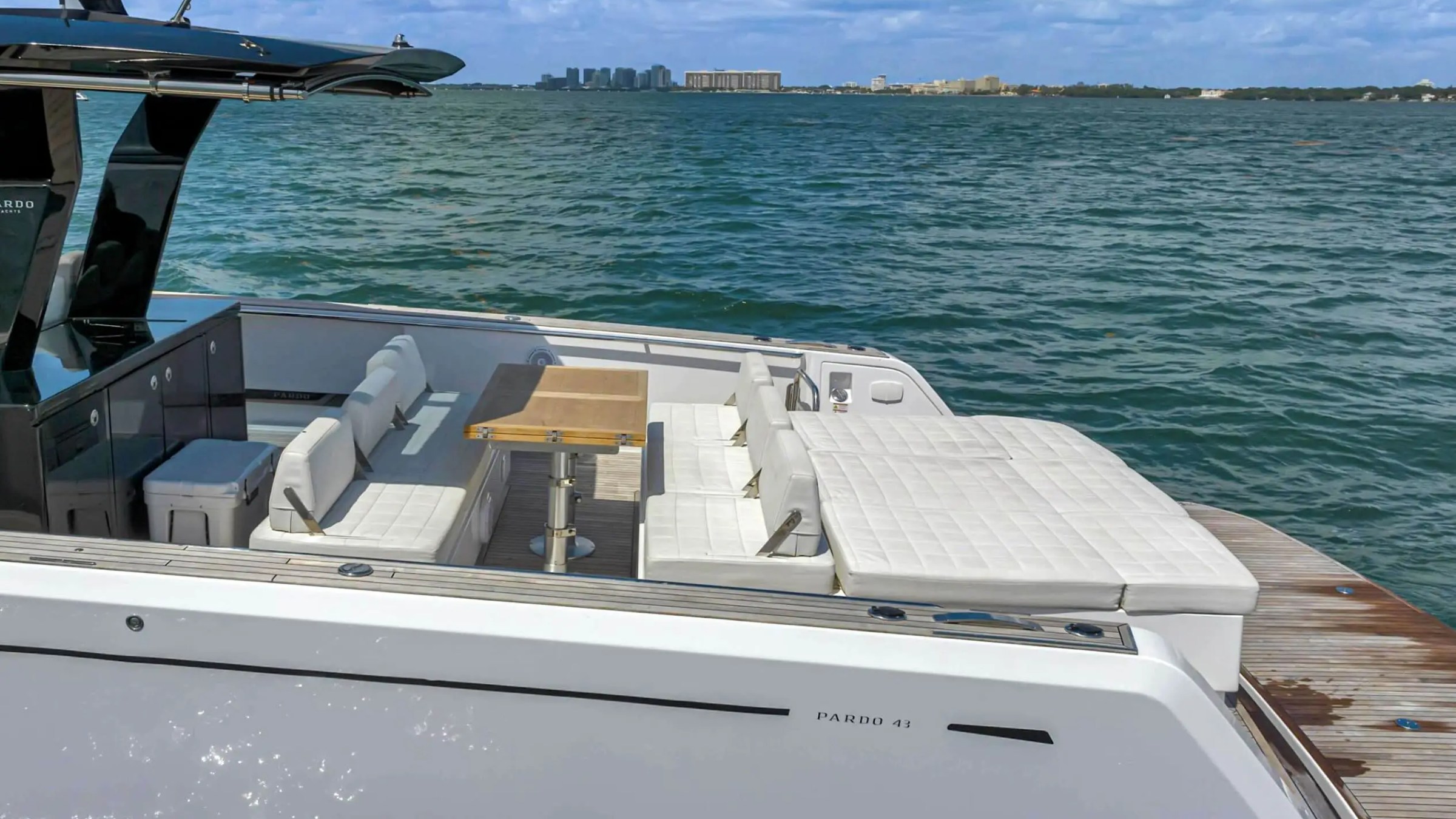 Foredeck seating with skyline backdrop aboard 43′ Pardo